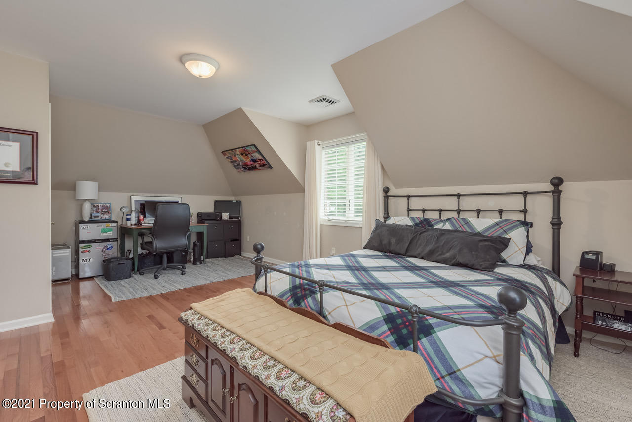 14 Kipling Drive Moosic, PA 18507 - Photo 22 of 42 a bedroom with a bed a table and chairs
