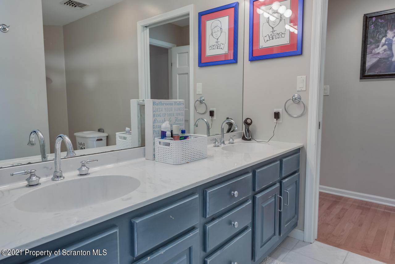 14 Kipling Drive Moosic, PA 18507 - Photo 23 of 42 a bathroom with a sink and a mirror