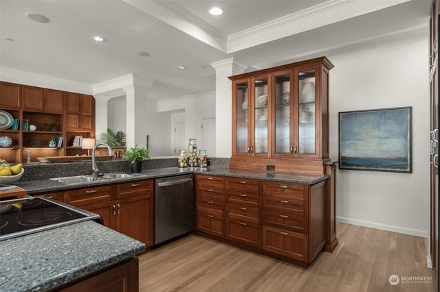 a kitchen with stainless steel appliances a stove a sink and a microwave