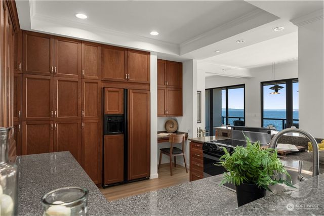 a kitchen with granite countertop a stove and a sink