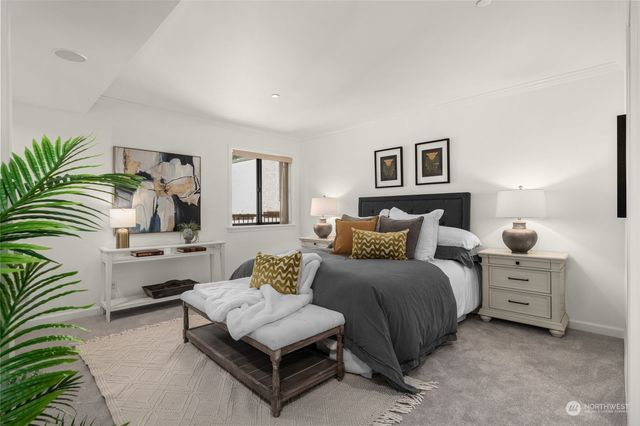 a bedroom with a bed a window and dresser