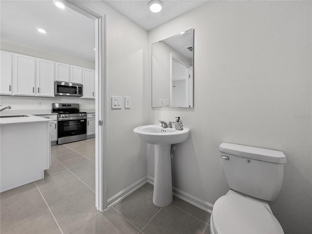 2735 Skyline Loop Kissimmee, FL 34758 - Photo 14 of 33 a bathroom with a toilet sink and a mirror