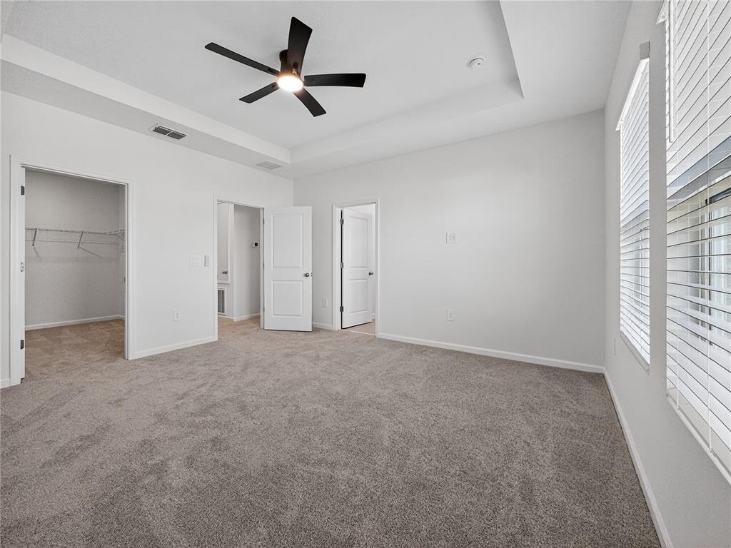 2735 Skyline Loop Kissimmee, FL 34758 - Photo 16 of 33 an empty room with a ceiling fan and window