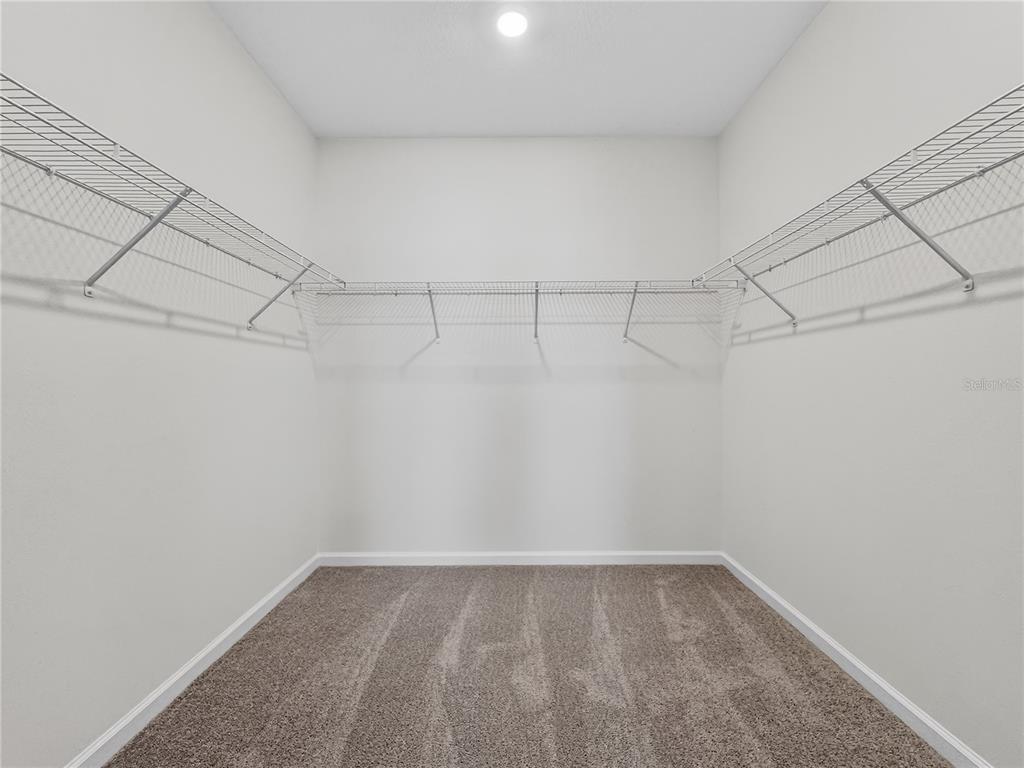 2735 Skyline Loop Kissimmee, FL 34758 - Photo 18 of 37 a view of a room with racks on the wall