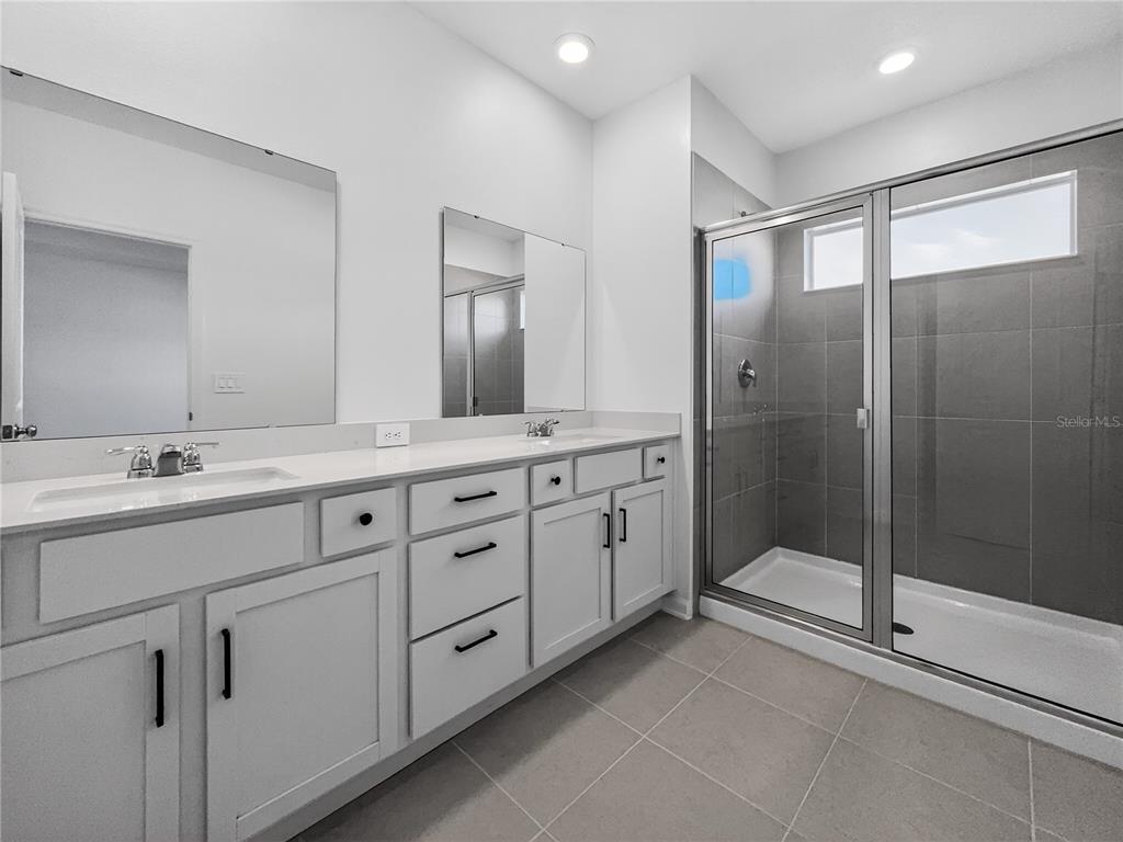 2735 Skyline Loop Kissimmee, FL 34758 - Photo 19 of 37 a spacious bathroom with double sink and a mirror