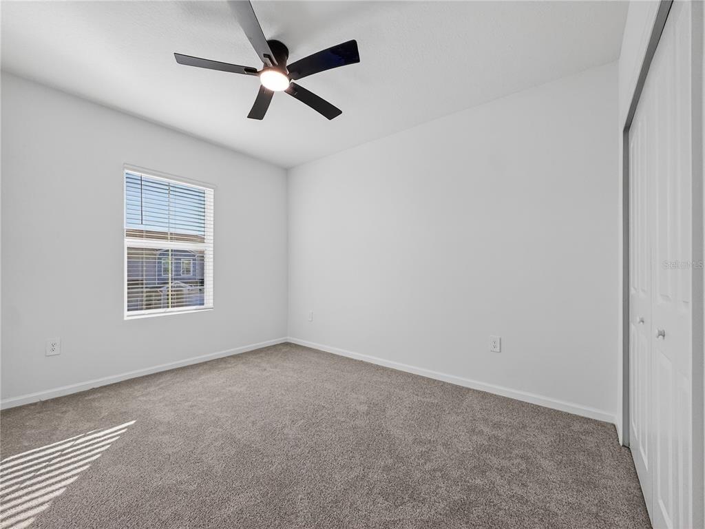2735 Skyline Loop Kissimmee, FL 34758 - Photo 19 of 33 an empty room with a window and a fan