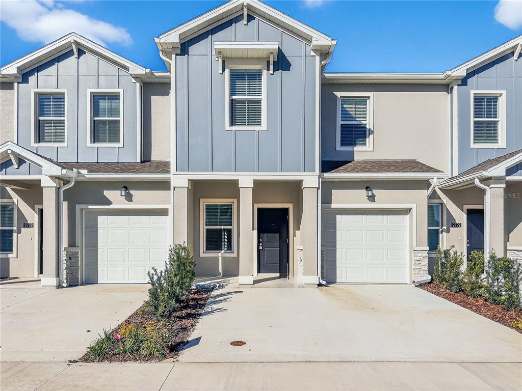 2735 Skyline Loop Kissimmee, FL 34758 - Photo 2 of 33 a front view of a house with garden