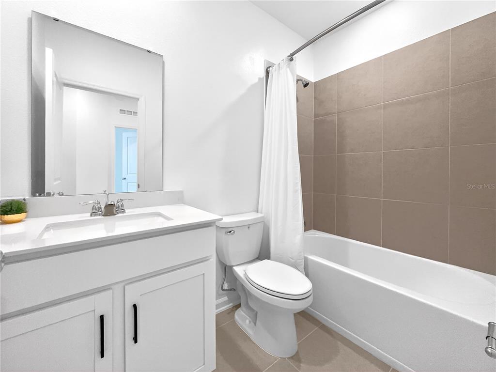 2735 Skyline Loop Kissimmee, FL 34758 - Photo 23 of 37 a bathroom with a sink a toilet and shower