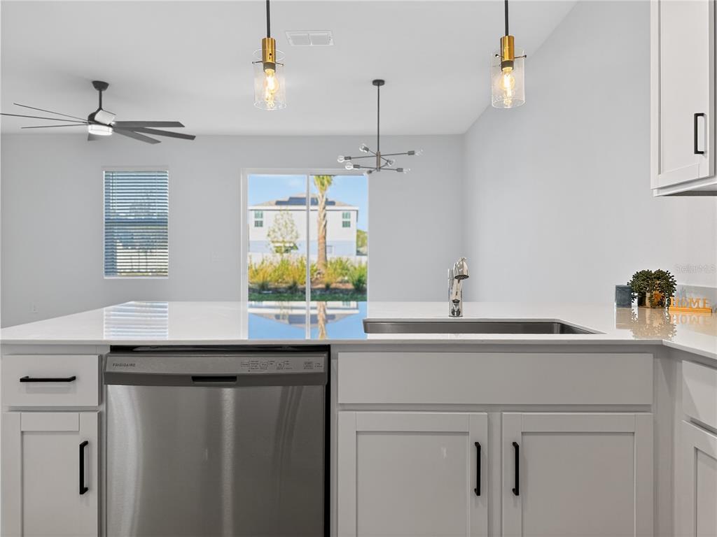 2735 Skyline Loop Kissimmee, FL 34758 - Photo 8 of 33 a kitchen with a sink and a refrigerator