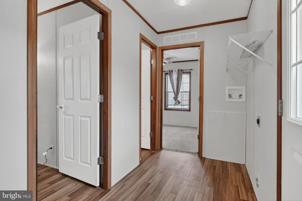 a view of a hallway with wooden floor