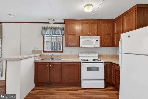 a kitchen with a stove a sink and a refrigerator