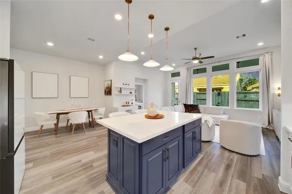 a living room with furniture kitchen view and a flat screen tv