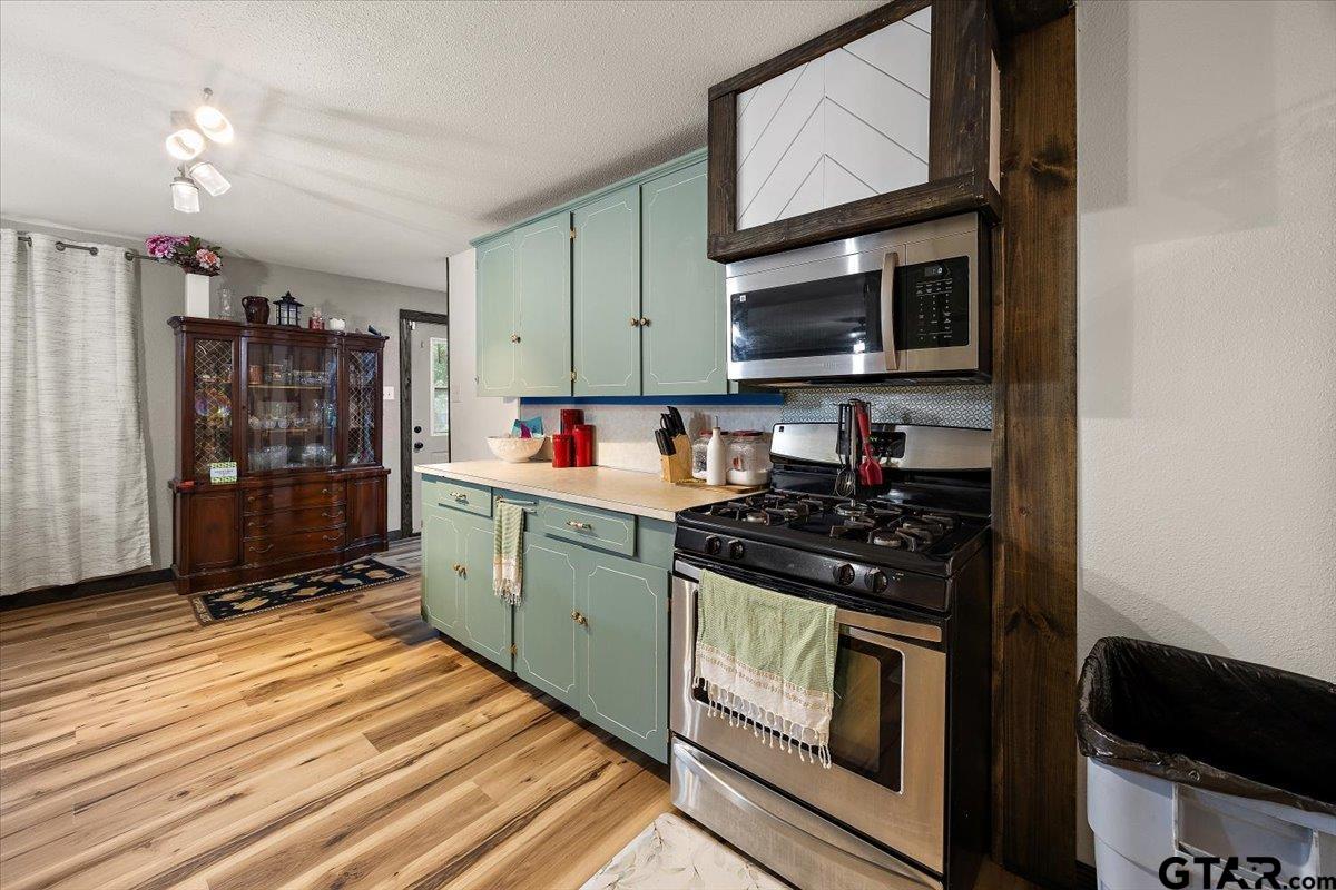 429 Main Street Rusk, TX 75785 - Photo 14 of 26 a kitchen with stainless steel appliances granite countertop a stove and a microwave