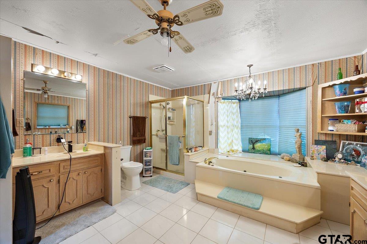 429 Main Street Rusk, TX 75785 - Photo 19 of 26 a large bathroom with a double vanity sink a mirror and a bathtub