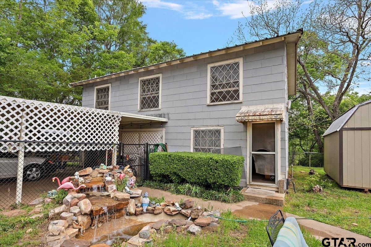 429 Main Street Rusk, TX 75785 - Photo 7 of 26 a front view of a house with a garden