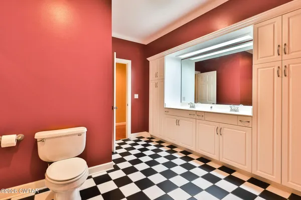 a bathroom with a toilet a sink and a shower
