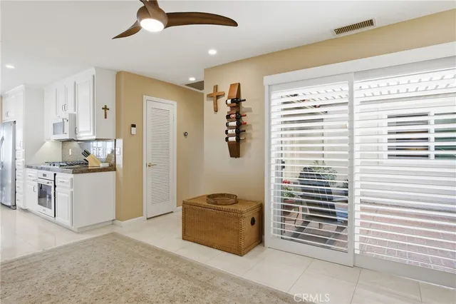 a kitchen with stainless steel appliances kitchen island granite countertop a refrigerator and a stove top oven