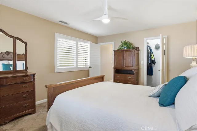 a bedroom with a bed and a television