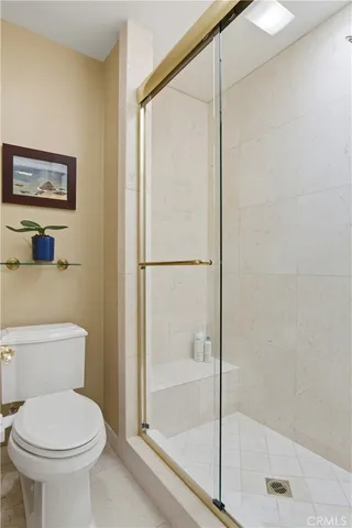 a bathroom with a toilet and a shower