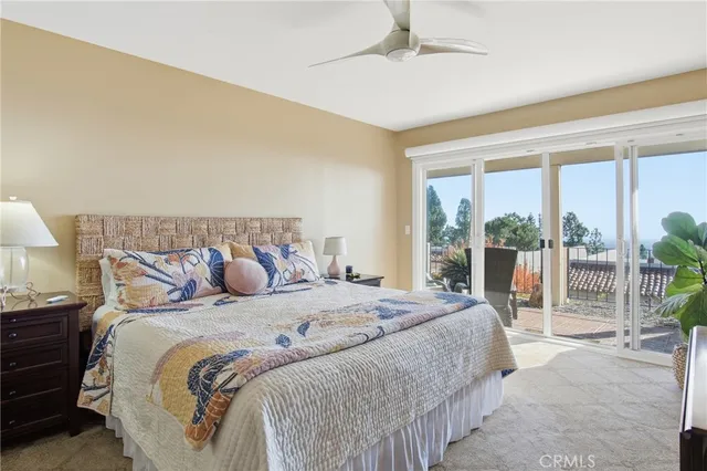a bedroom with a large bed and a balcony