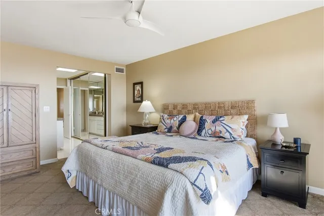 a bedroom with a bed and a lamp