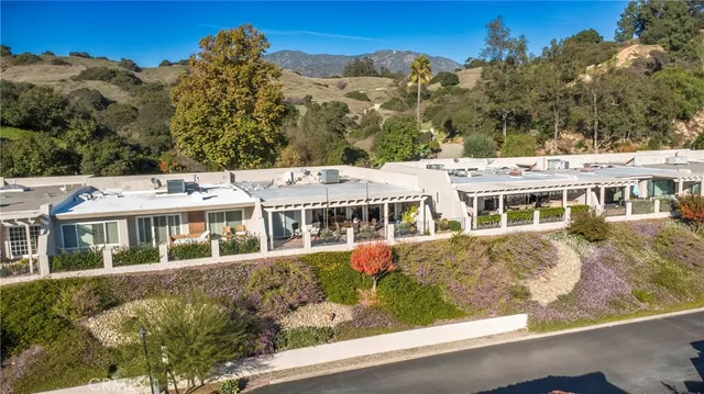 a view of a house with floor to ceiling windows and a basket ball poll