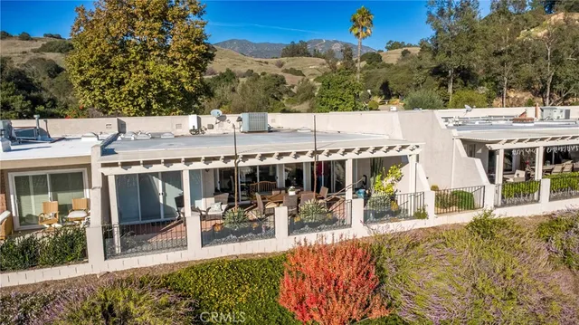 a view of a balcony with city view and wooden fence