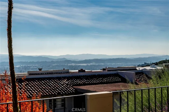 a view of balcony with wooden floor and a mountain view