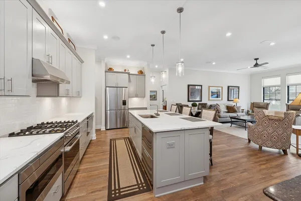 a large kitchen with stainless steel appliances lots of counter space and a sink