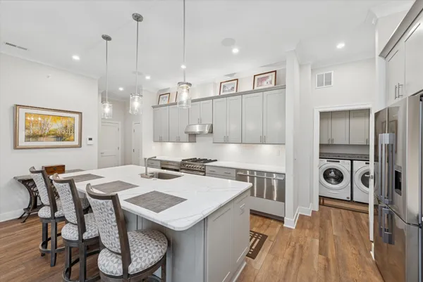 a large kitchen with a table and chairs