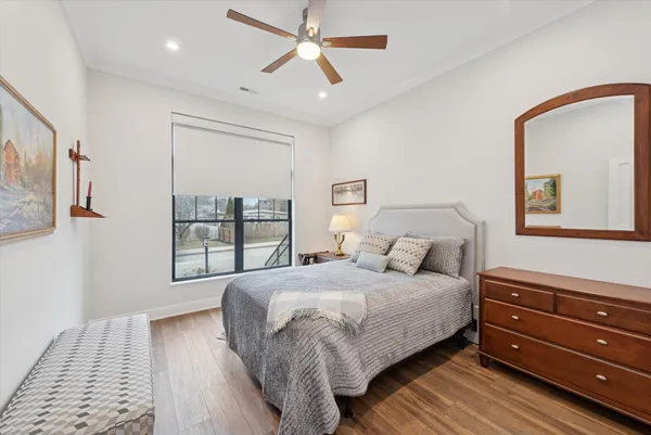 a bedroom with a large bed and a window