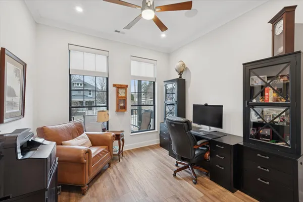 a view of a workspace with furniture and a window