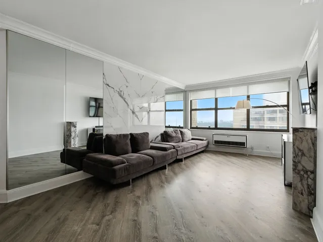 a living room with furniture and a floor to ceiling window