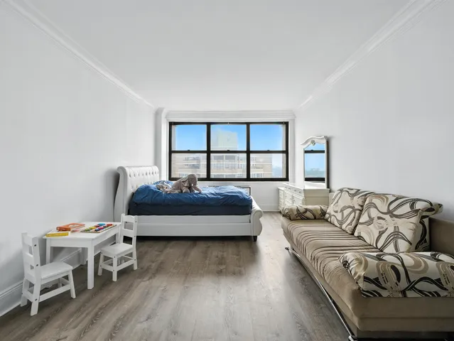 a bedroom with a bed and a couch