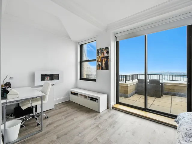 a view of a room with gym equipment and floor to ceiling window