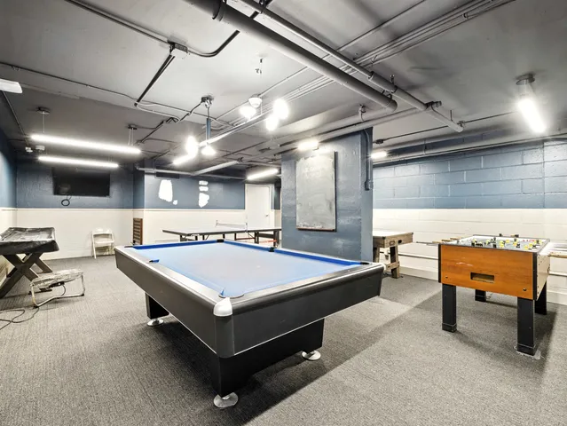 a room with pool table and a chair
