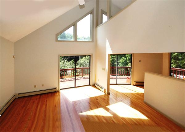 187 Wilbraham Road Monson, MA 01057 - Photo 6 of 22 a view of an empty room with wooden floor and a window