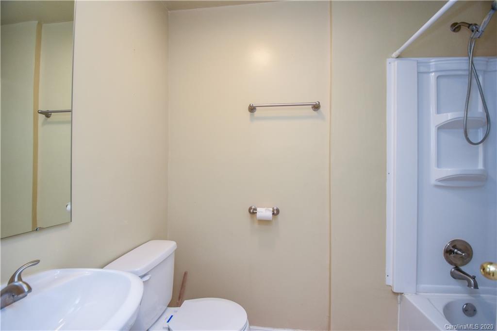 8716 Chalkstone Road Charlotte, NC 28216 - Photo 11 of 31 a white toilet sitting next to a bathroom sink