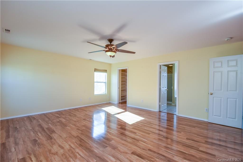8716 Chalkstone Road Charlotte, NC 28216 - Photo 13 of 31 a view of a big room with wooden floor and windows
