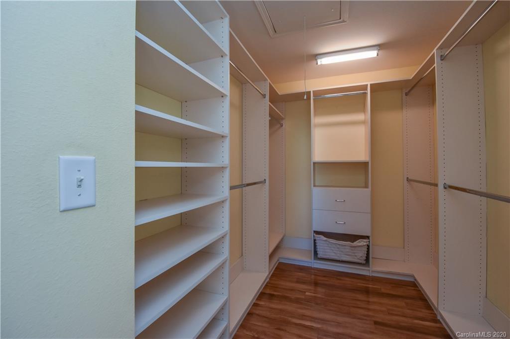 8716 Chalkstone Road Charlotte, NC 28216 - Photo 16 of 31 a view of walk in closet with empty racks