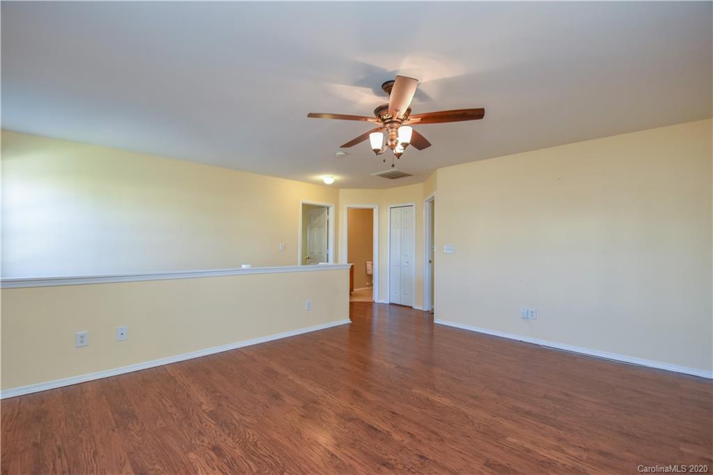 8716 Chalkstone Road Charlotte, NC 28216 - Photo 20 of 31 a view of an empty room with wooden floor