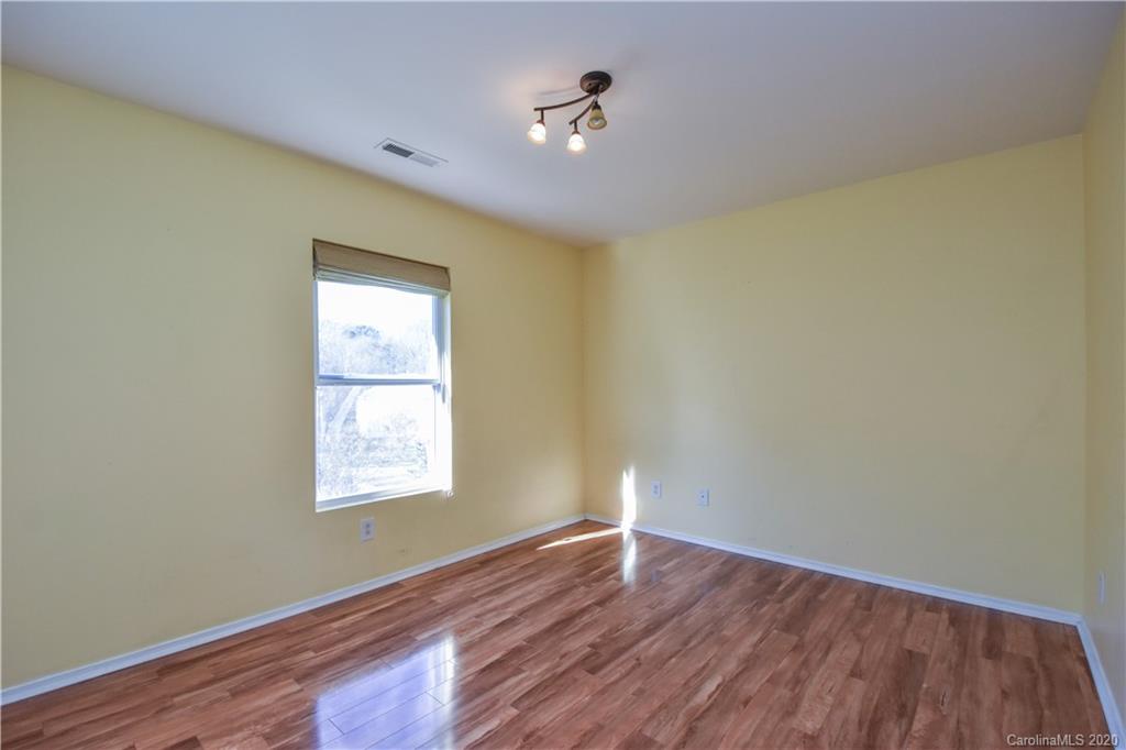 8716 Chalkstone Road Charlotte, NC 28216 - Photo 21 of 31 an empty room with wooden floor and windows