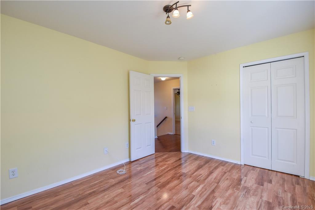 8716 Chalkstone Road Charlotte, NC 28216 - Photo 23 of 31 a view of an empty room with wooden floor