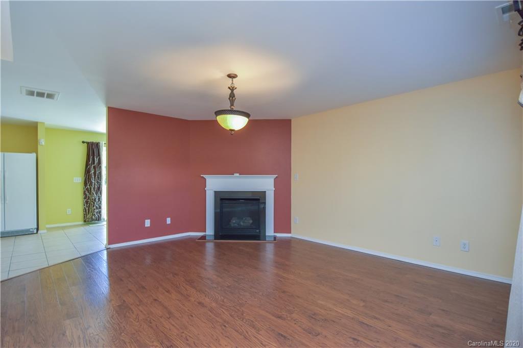 8716 Chalkstone Road Charlotte, NC 28216 - Photo 5 of 31 a view of an empty room with wooden floor