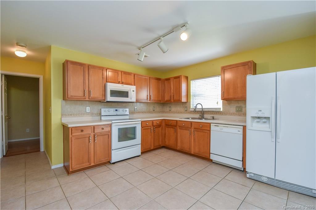 8716 Chalkstone Road Charlotte, NC 28216 - Photo 6 of 31 a kitchen with granite countertop cabinets stainless steel appliances and a counter top space
