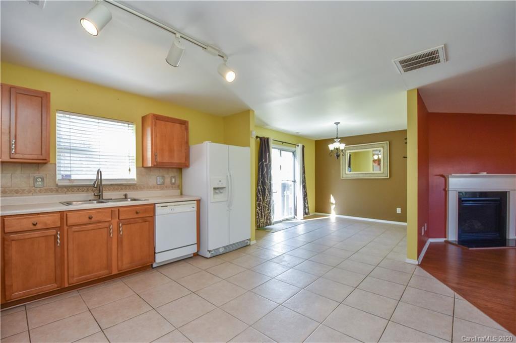 8716 Chalkstone Road Charlotte, NC 28216 - Photo 7 of 31 a view of a kitchen with a sink cabinets and a window