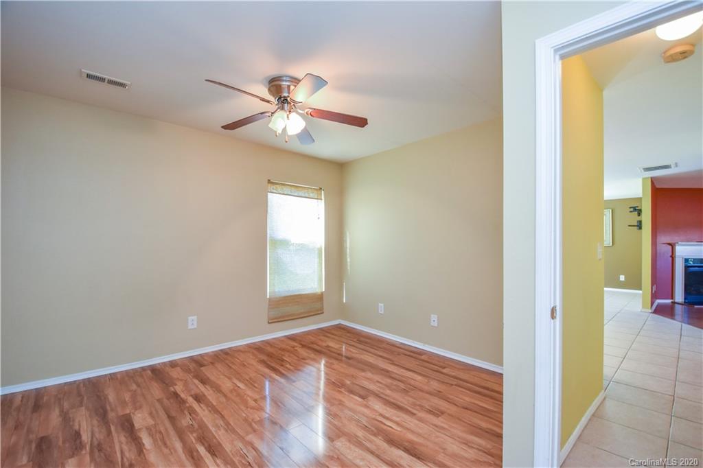 8716 Chalkstone Road Charlotte, NC 28216 - Photo 10 of 31 a view of an empty room with wooden floor and a window