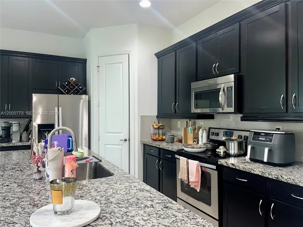 a kitchen with a sink appliances and cabinets