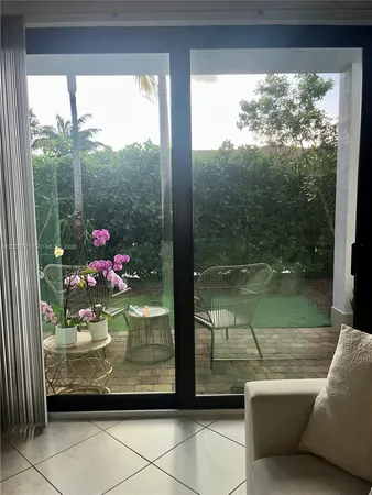 a view of a living room with a floor to ceiling window and a floor to ceiling window