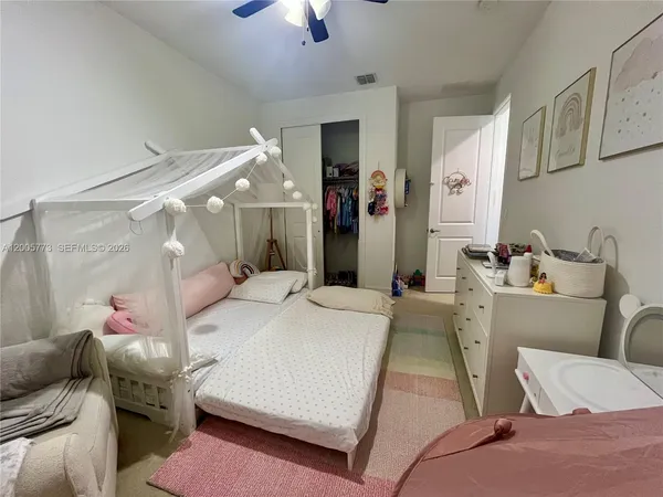 a spacious bedroom with a bed and window